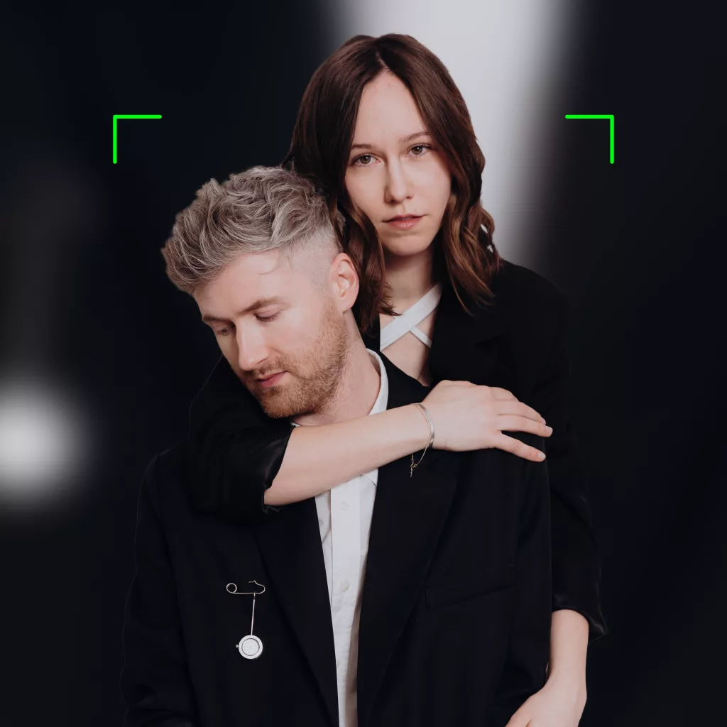 Cara and Mark from 32after posing in an intimate and cinematic style for promotional image.