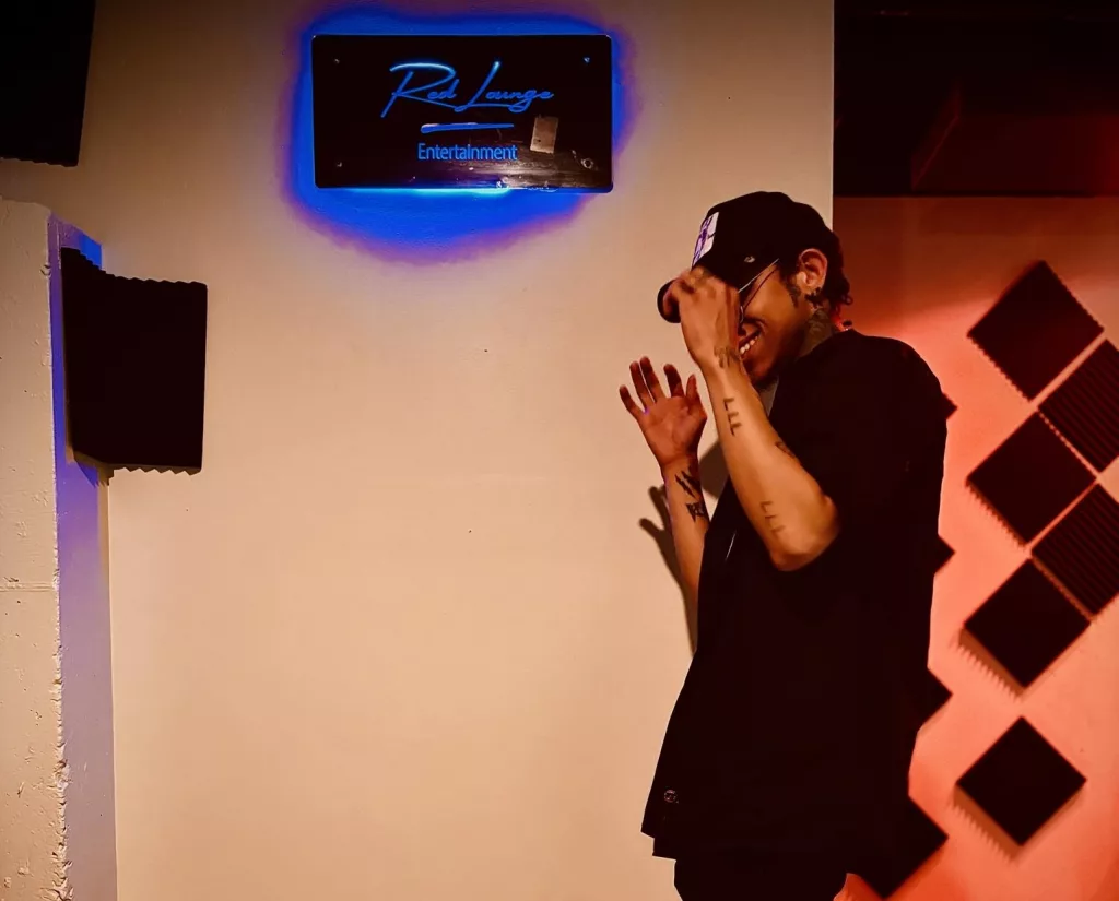 Kid Rose, artist from Lancaster, Pennsylvania, posing in a recording studio with a retro-inspired vibe.